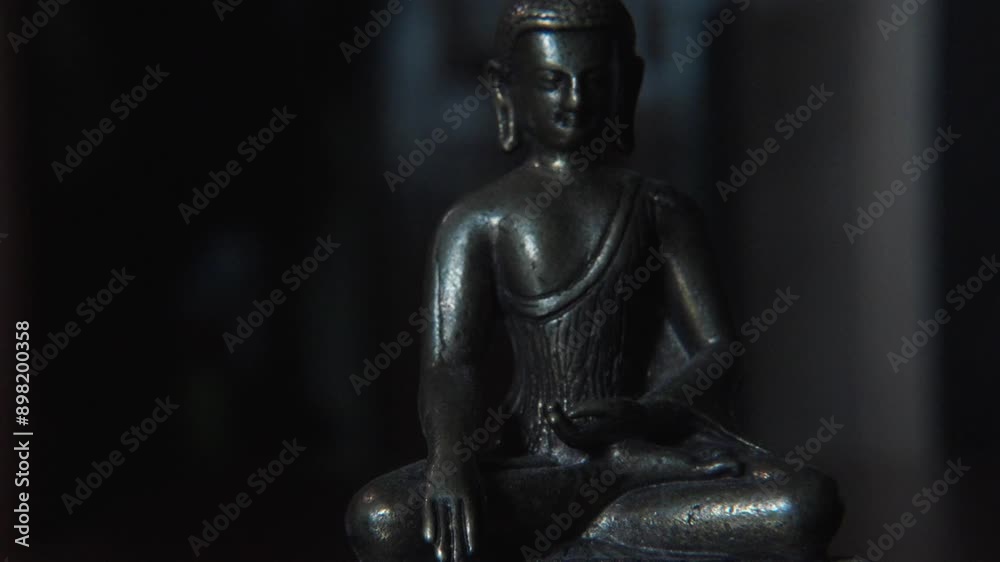 Close-up Buddah figure with changing light on a dark background. Close-up Buddah figure with changing light on a dark background.