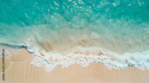 Blue ocean waves aerial drone shot on sandy beach