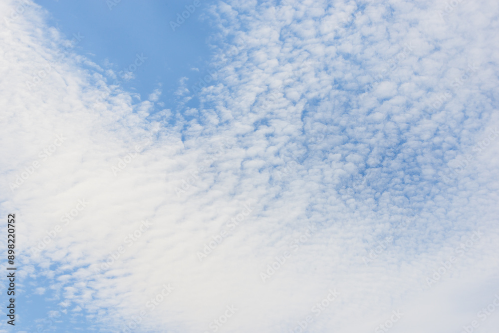 Blue sky and white spindrift clouds background, texture, cloudscape Blue sky and white spindrift clouds background, texture, cloudscape