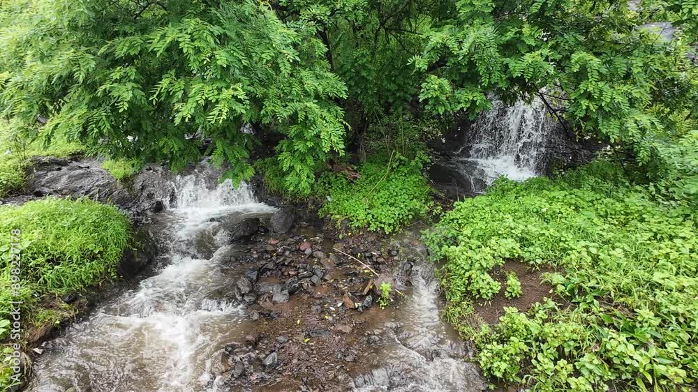 a small stream flowing through lush green grass, creating a peaceful natural landscape. a small stream flowing through lush green grass, creating a peaceful natural landscape.