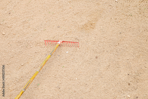 A sand rake with the emtry brown ground.