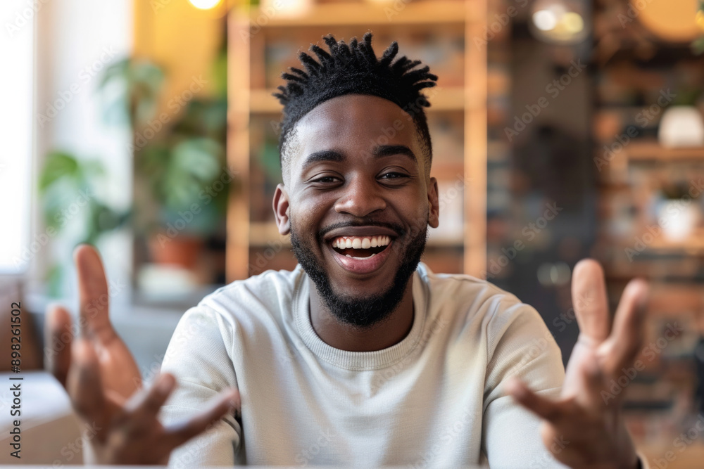 Smiling man with dreadlocks chats on video call inside home Smiling man with dreadlocks chats on video call inside home
