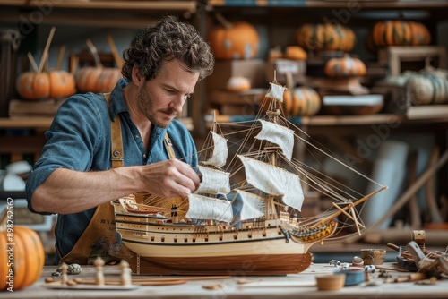 Serene Man Building Model Ship as a Therapeutic Activity, Focused Mental Health Hobby in Pumpkin-Colored Attire