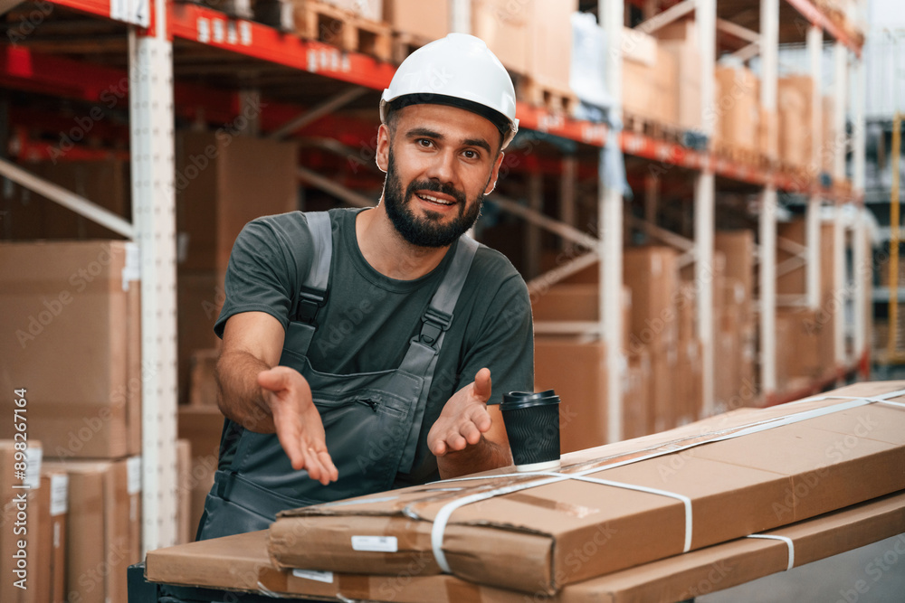 Showing packages by hand. Foreman is in the storehouse, shipping distribution business Showing packages by hand. Foreman is in the storehouse, shipping distribution business