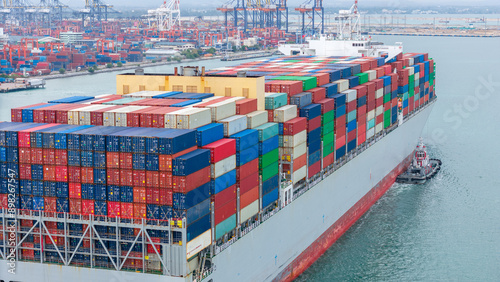 Photography stern of Cargo container ship carrying container and running in international container port customs shipyard sea port concept smart logistic service