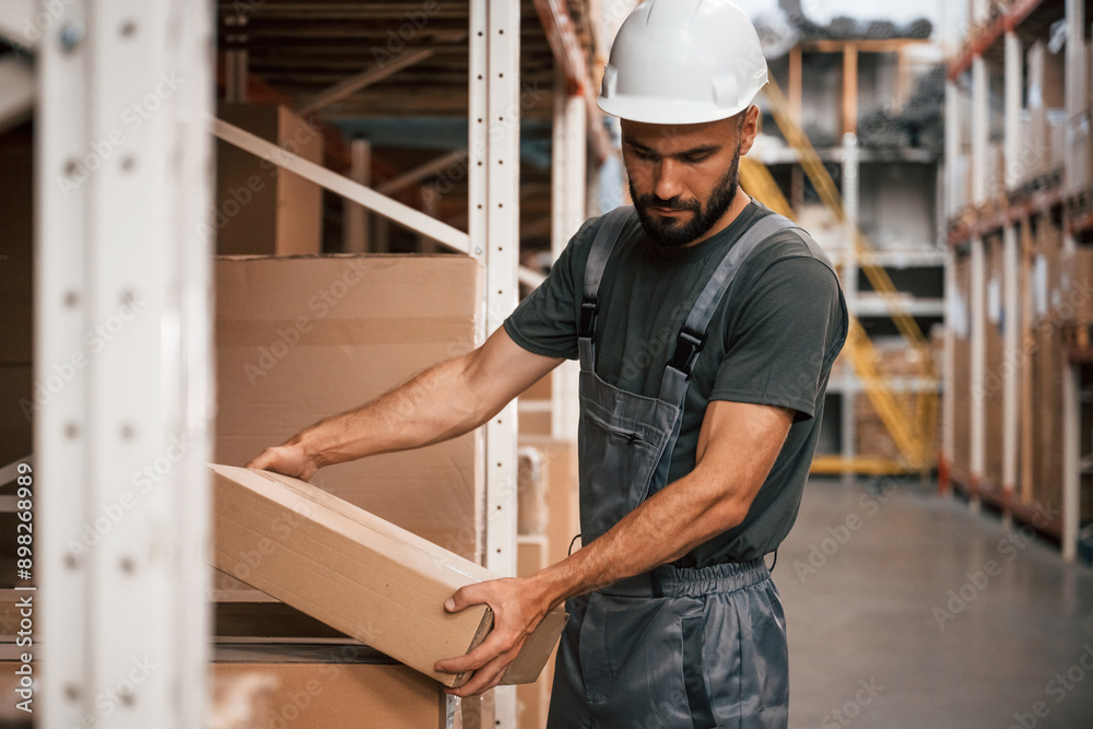 Package in hands. Foreman is in the storehouse, shipping distribution business Package in hands. Foreman is in the storehouse, shipping distribution business