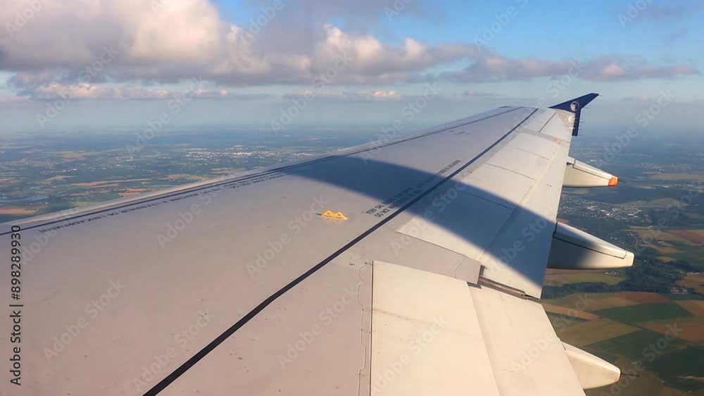 Airplane wing flying over summer landscape in Europe Airplane wing flying over summer landscape in Europe