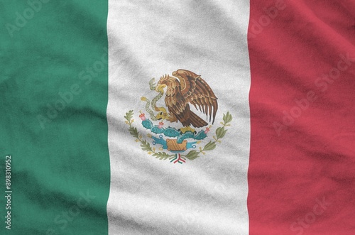 Mexico flag depicted on folded wavy fabric of old cloth close up