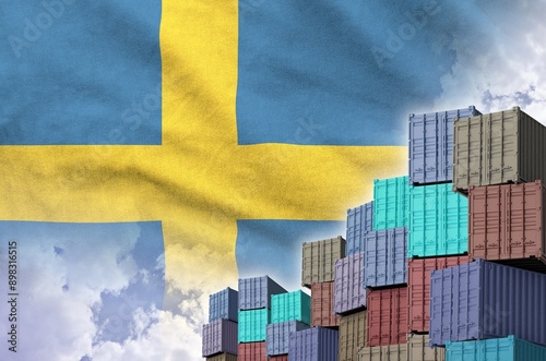 Sweden flag and big stack of shipping cargo containers in docks with sky background close up photo