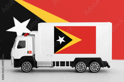 Timor Leste flag depicted on side wall of white delivery van close up. Shipping and local delivery concept photo