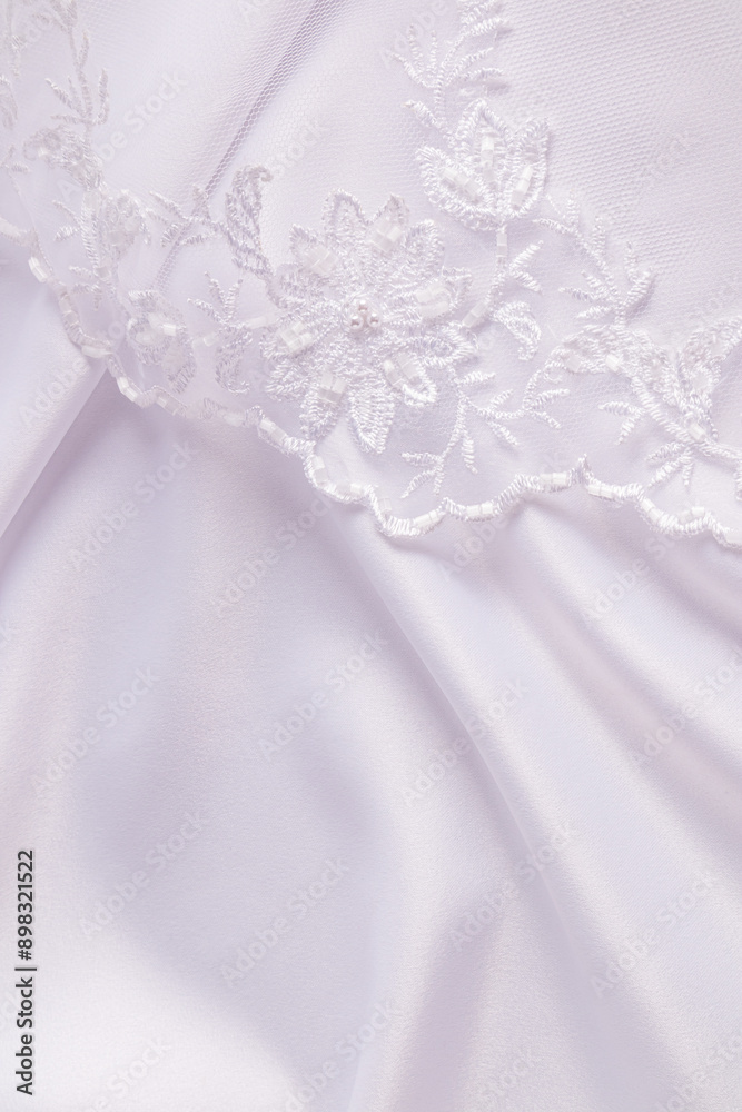 white wedding satin with soft pleats and embroidered tulle lace, bridal veil. vertical view. A copy space. Wedding design concept. white wedding satin with soft pleats and embroidered tulle lace, bridal veil. vertical view. A copy space. Wedding design concept.