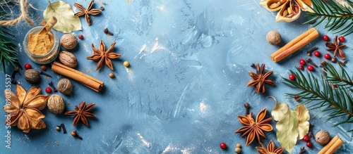 Fototapeta Naklejka Na Ścianę i Meble -  View from above of Christmas spices on a blue background with copy space image available
