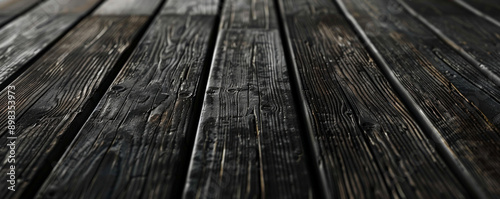 Dark charcoal wooden floors backdrop, providing a dramatic and striking background for your website or wallpaper designs with plenty of room for text or graphic elements.