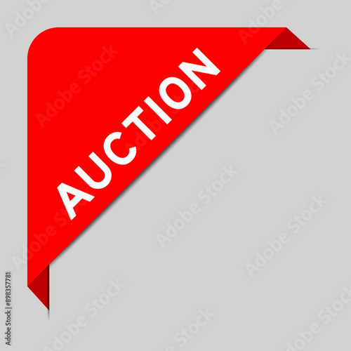 Red color of corner label banner with word auction on gray background