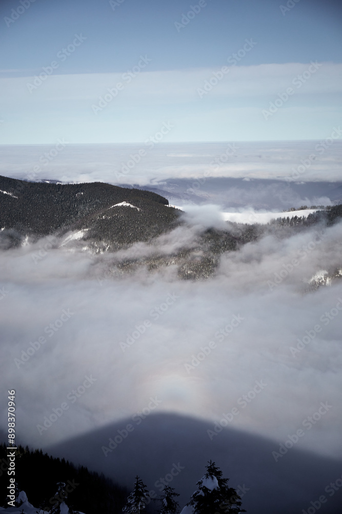 Aerial View Of A Snowy Mountain Range Covered In Fog On A Winter Day. Winter touristic trails in Carpathian mountains, Ukraine Aerial View Of A Snowy Mountain Range Covered In Fog On A Winter Day. Winter touristic trails in Carpathian mountains, Ukraine