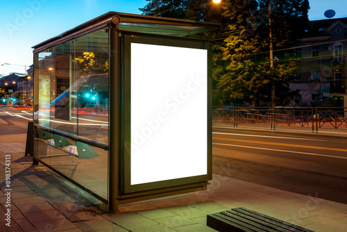 Fototapeta Naklejka Na Ścianę i Meble -  Mockup Of Bus Stop Advertising Billboard In City Street At Night. Poster Light Box With Car Light Streaks