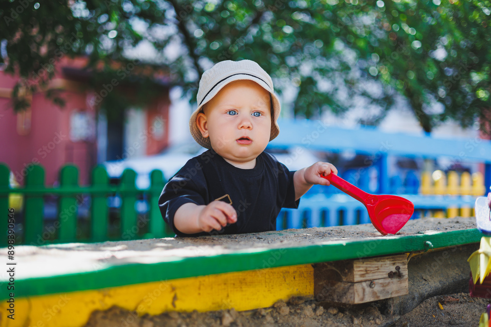 A baby boy in a panama on his head is playing on the playground. A child walking on the street. A baby boy in a panama on his head is playing on the playground. A child walking on the street.