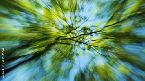 Blurred green tree branch against sky in abstract