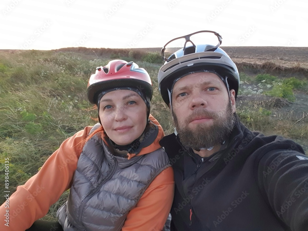 Cyclists - travelers take selfies against the background of nature in the evening.
