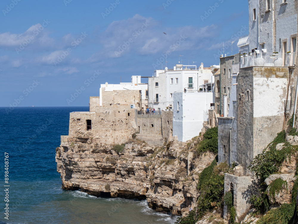 Scenic view of a cliffside town in Italy with historic buildings overlooking the Mediterranean Sea. Captures the picturesque and cultural essence of coastal Italian architecture. Scenic view of a cliffside town in Italy with historic buildings overlooking the Mediterranean Sea. Captures the picturesque and cultural essence of coastal Italian architecture.