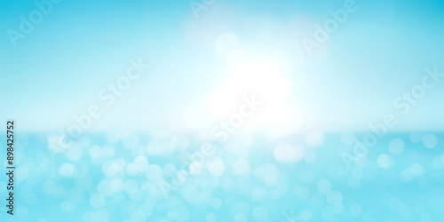Obraz na płótnie A bright blue background of a warm spring, summer sky and distant horizon over a blue ocean or sea with light reflecting off the surface from sun flare on the right. w salonie