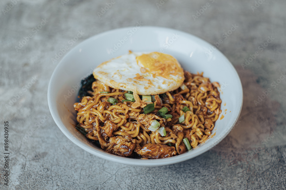 Mie Bangladesh with boiled egg and some vegetables made from instant noodles originate from Medan or Aceh. Typical Southeast Asian food. Mie Bangladesh with boiled egg and some vegetables made from instant noodles originate from Medan or Aceh. Typical Southeast Asian food.