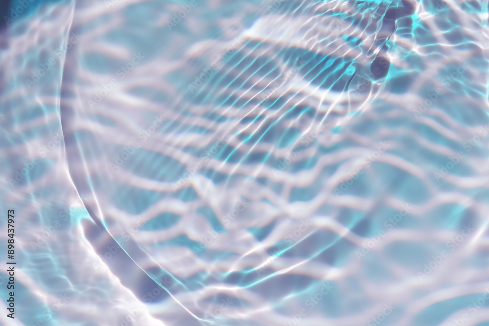 Naklejka premium Blue water with ripples on the surface. Defocus blurred transparent blue colored clear calm water surface texture with splashes and bubbles. Water waves with shining pattern texture background.