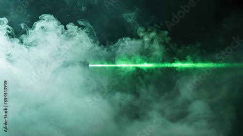 Green laser beam in a dark environment with swirling white smoke