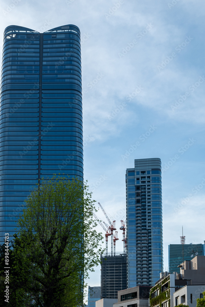 Fototapeta premium Tokyo city skyscrapers against blue sky, Japan