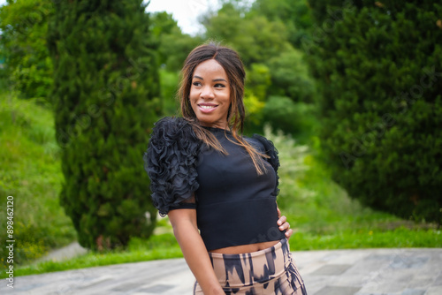 Chic latin woman posing while dancing salsa in a park