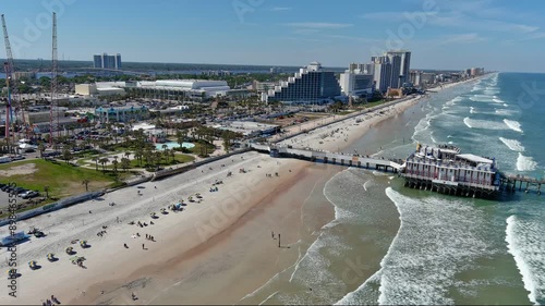 Daytona Beach Aerial Pan east then turn to pier & coast