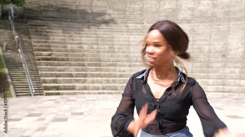 Latin beauty woman gesturing gentile dancing salsa in a park