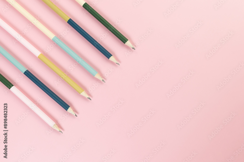 Top view of colorful pencils on pink background. School, office, art wallpaper. Flat lay, copy space. Top view of colorful pencils on pink background. School, office, art wallpaper. Flat lay, copy space.