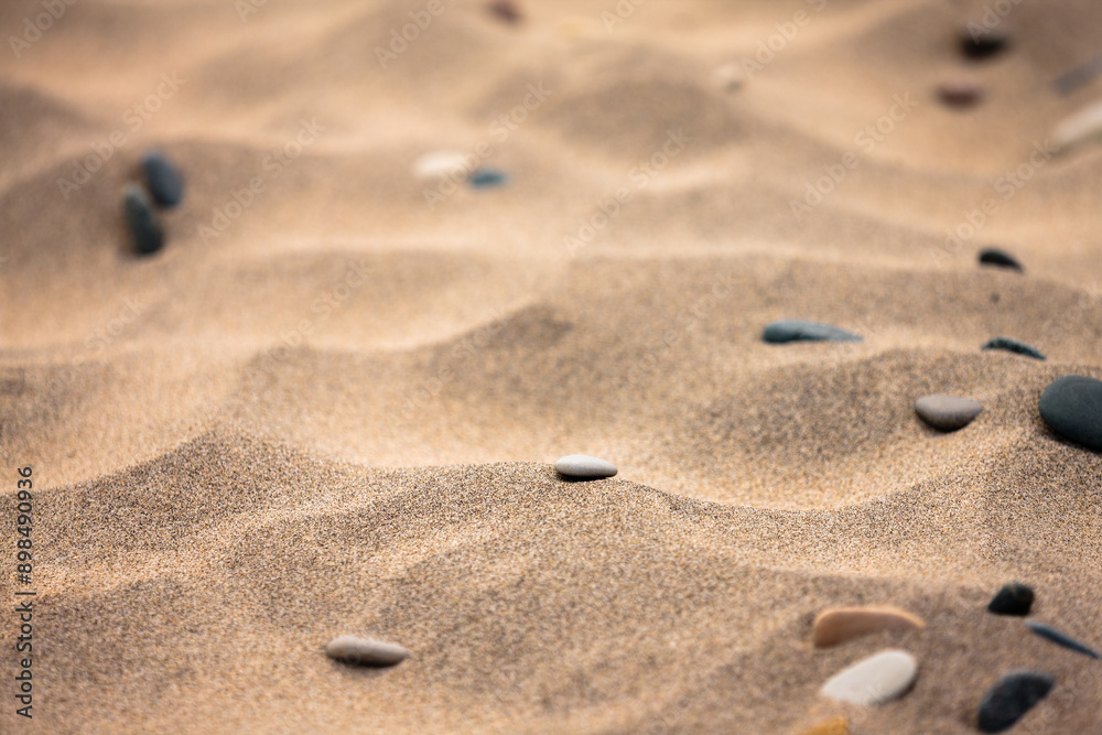 Stones rest peacefully among the indentations of the beach sand at Kohler-Andrae State Park, Sheboygan, Wisconsin in late June Stones rest peacefully among the indentations of the beach sand at Kohler-Andrae State Park, Sheboygan, Wisconsin in late June