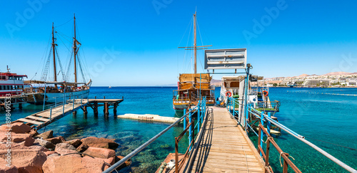 Pleasure yachts and sailboats anchored near stone pier in marina of the Red S...