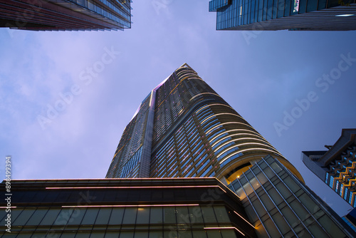 Photography Looking up  at a large skyscraper in Hong Kong during a twilight sky