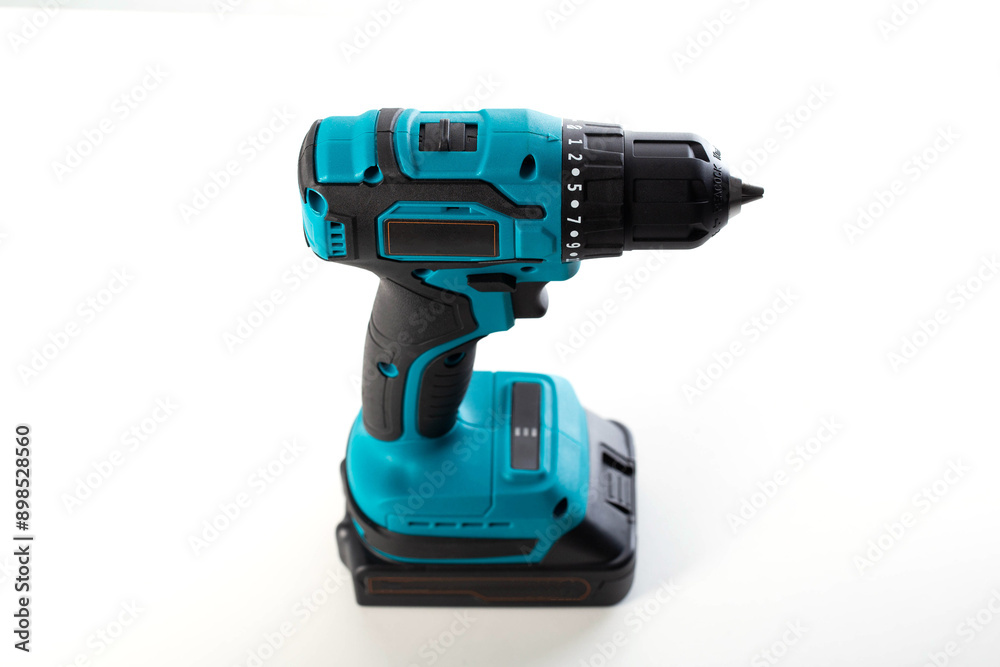 Modern cordless drill-driver on a white background, isolate. Modern screwdriver with quick-release chuck. Copy space for text Modern cordless drill-driver on a white background, isolate. Modern screwdriver with quick-release chuck. Copy space for text