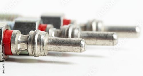 Modern ceramic glow plugs for warming up a diesel engine before starting. White background, isolate. Macro photo