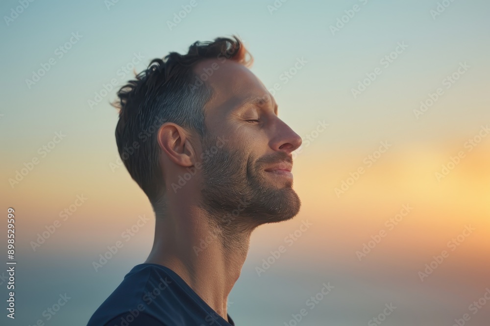 Serene Man Practicing Deep Breathing at Sunrise for Mental Health Wellness, Wearing Navy Clothing Serene Man Practicing Deep Breathing at Sunrise for Mental Health Wellness, Wearing Navy Clothing