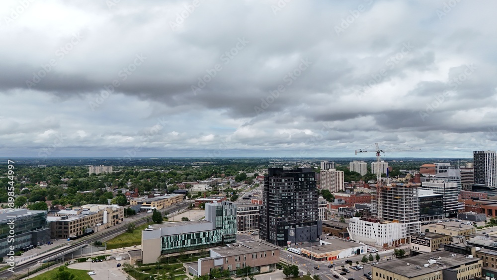 Obraz premium Aerial view of the cityscape of Waterloo with greenery under stormy clouds in Ontario, Canada.