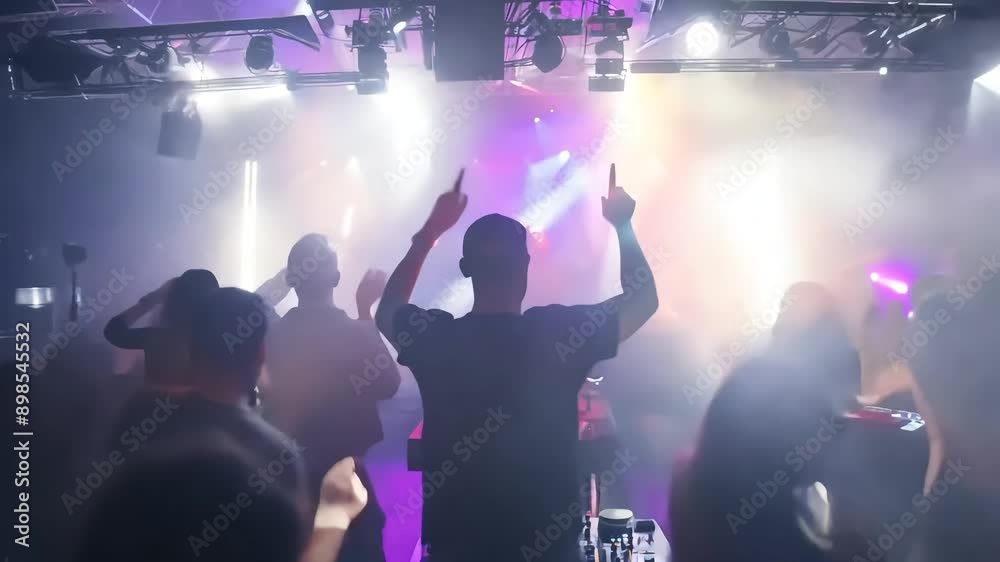 Shadowy figure throws their hands up, embracing the energy of the crowd and pulsating stage lights at a concert. Shadowy figure throws their hands up, embracing the energy of the crowd and pulsating stage lights at a concert.