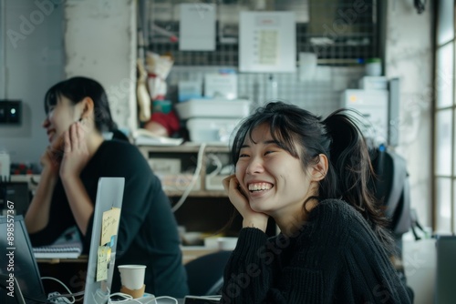 Young asian businesswoman smiling and looking at camera in office.