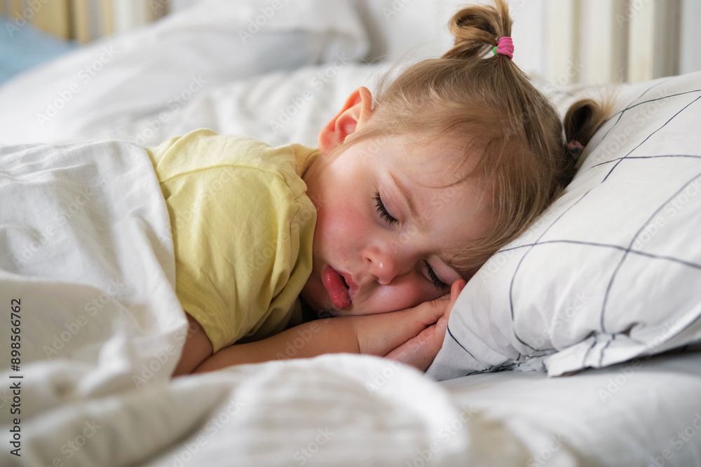 Peaceful adorable baby sleeping on a bed at home. Slumbering little child. Two years old girl sleeps peaceful at domestic room interior background. Serene dream. Cute face close up. Deep kid slumber Peaceful adorable baby sleeping on a bed at home. Slumbering little child. Two years old girl sleeps peaceful at domestic room interior background. Serene dream. Cute face close up. Deep kid slumber