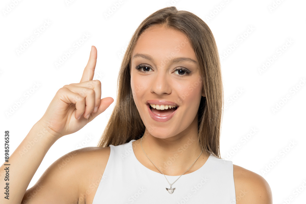 Young woman happy and pointing up isolated on white background Young woman happy and pointing up isolated on white background