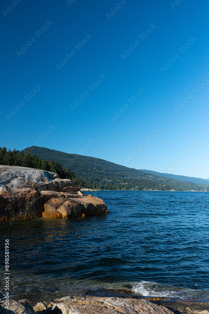 Rocky shore of Lake Tahoe with blue sky and clouds in summer Rocky shore of Lake Tahoe with blue sky and clouds in summer