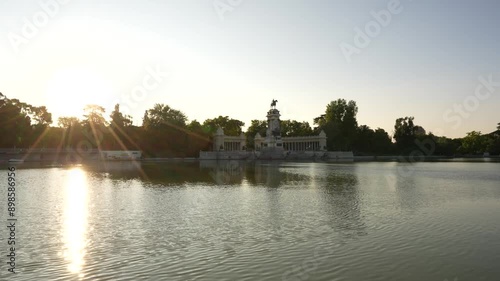 Retiro Park Madrid, Spain Sunrise at the Monument to Alfonso XII. Sun Flare Calm Waters Pond at European Travel Tourism Destination photo