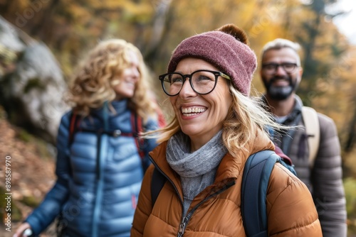 Photo of a group of friends hiking on a nature trail, smiling and laughing. Hiking and outdoor adventure concept. 