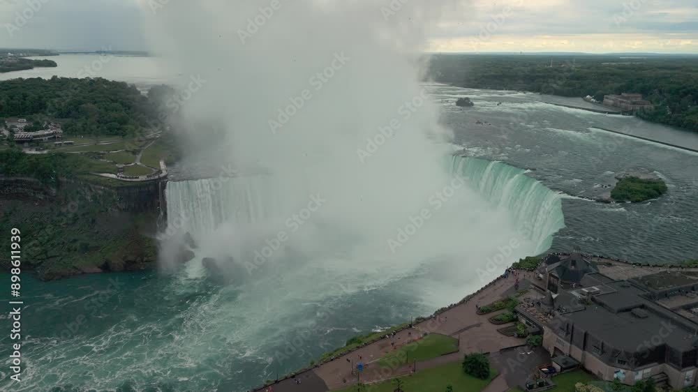 Aerial view of Niagara Falls on an overcast afternoon. The video showcases the powerful waterfalls and the dramatic cloud cover, creating a captivating and surreal atmosphere. Aerial view of Niagara Falls on an overcast afternoon. The video showcases the powerful waterfalls and the dramatic cloud cover, creating a captivating and surreal atmosphere.