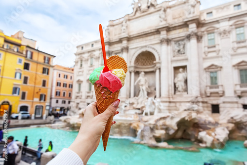 Italian ice cream gelato in front of amazing Trevi Fountain in Rome, Italy.