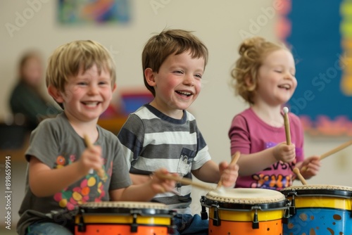 Three children are smiling while playing drums in a classroom setting.